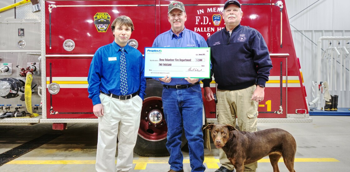 Members of Peoples Bank and Reno Volunteer Fire Department stand together for a $1,000 check presentation